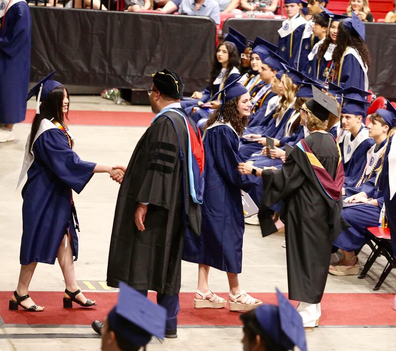 Graduates shake hands with Dr. Andalib Khelghati, Superintendent of Schools and Mrs. Laura Bankowski, prinicpal, at the Oswego High School Class of 2024 Commencement Ceremony on Saturday, May 18, 2024 in DeKalb.