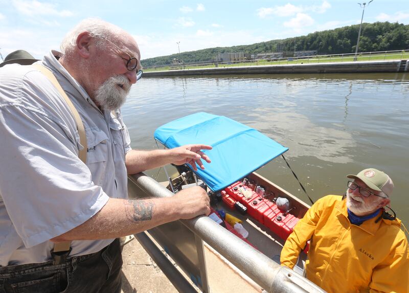 Jake Krancic of Oglesby, talks with 71 year old adventurer and thyroid cancer survivor Robert Youens, while locking at the Starved Rock Lock and Dam on Monday, July 28, 2025 near Utica. Krancic did the Great Loop in 2016 and took him a year to complete it.