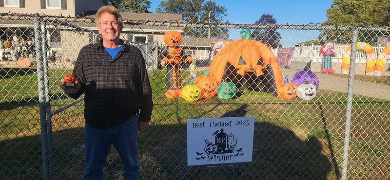 Dave Oredean holds up his pumpkin award for Best Themed in the 2025 Halloween House Decorating Contest sponsored by Rock Falls Tourism.