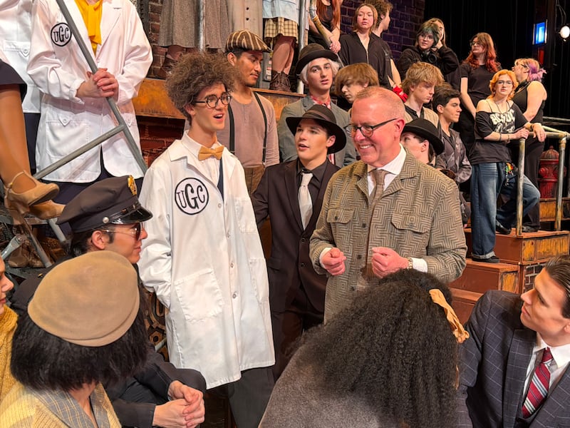 Cary-Grove High School Musical Director Rob Boncosky directs the cast of "Urinetown" before a show on March 8, 2026.