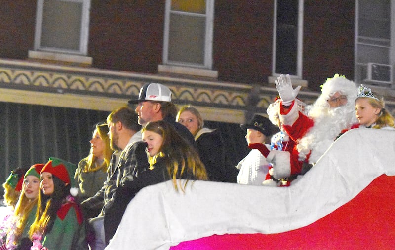 Santa waves to the crowd as he rides in his sleigh in the lighted parade at Morrison's Christmas Walk on Saturday, Dec. 7, 2024.