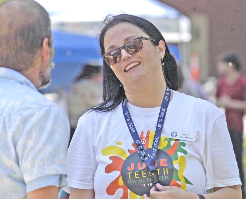 Sterling Mayor Diana Merdian talks to an attendee Saturday, June 21, at the Sauk Valley Diversity Alliance's Juneteenth celebration at the Grandon Civic Center in Sterling.