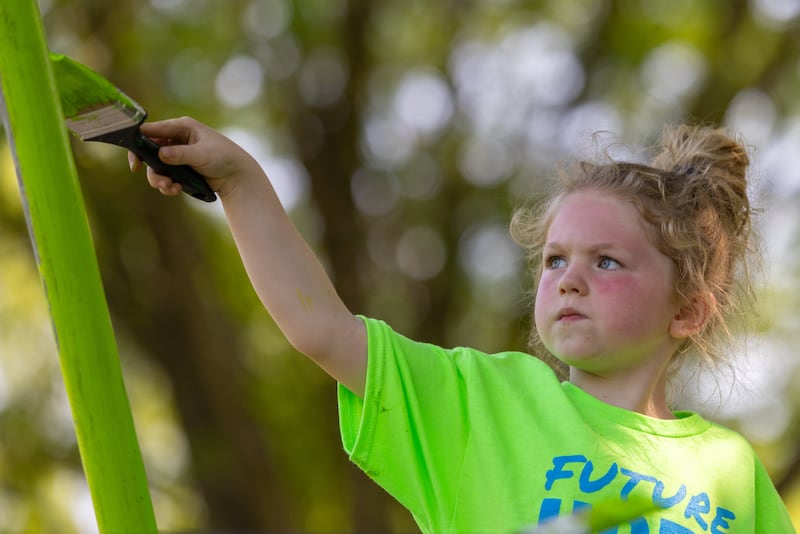 Skylar Hagemann paints a swing set post as part of Hope Week at Mary Hegeler Carus Memorial Park on June 1, 2025 in LaSalle.