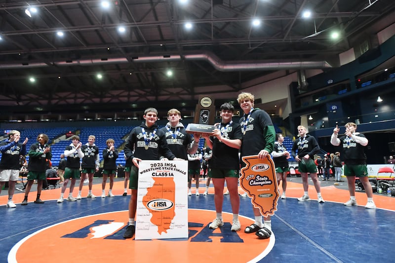 Coal City captains receive the Class 1A championship trophy at the IHSA Dual Team State Finals on Saturday, March 1.