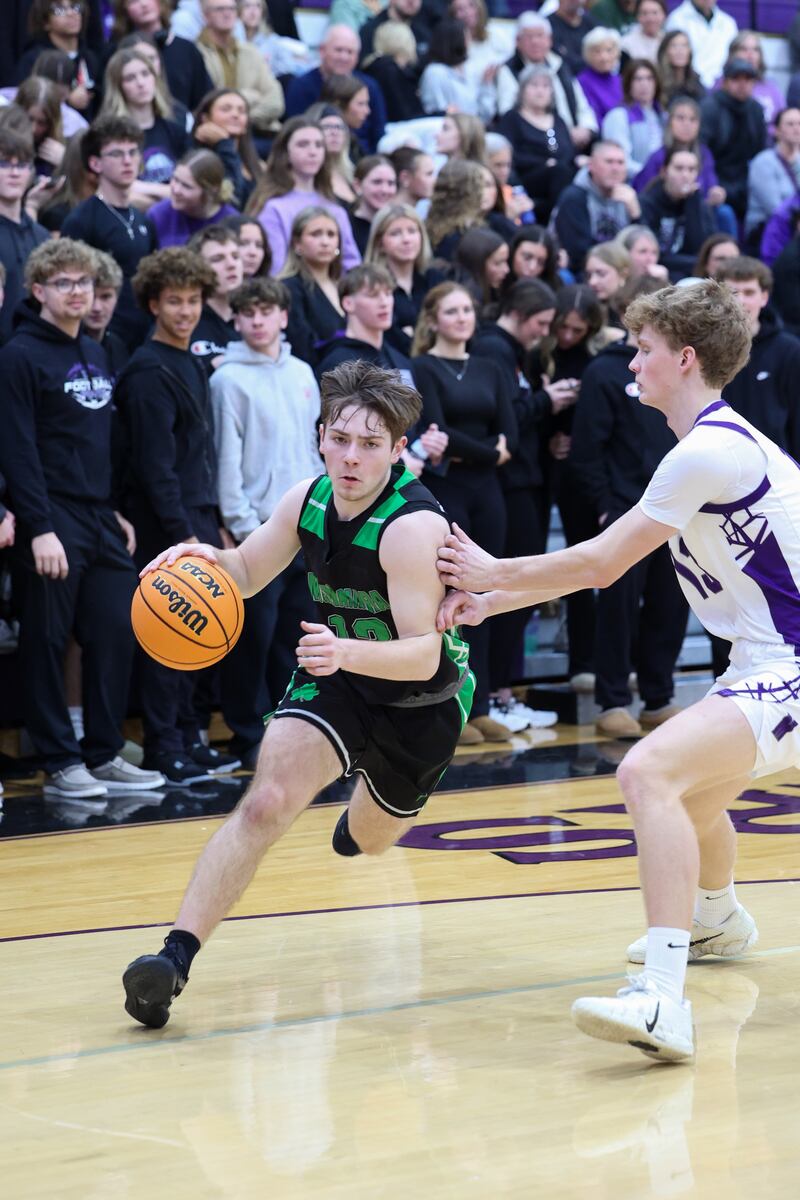 Bishop McNamara's Teddy Fogel drives toward the lane against Manteno's Ramsey Owens during the Fightin' Irish's 61-24 victory over Manteno on Tuesday, Jan. 13, 2026.