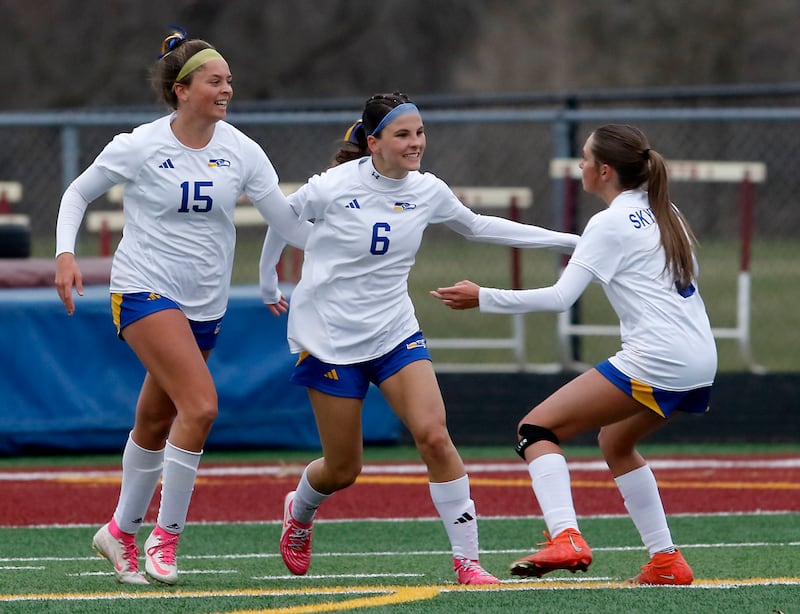 Johnsburg's Elizabeth Smith (center) celebrates her goal with teammates, Lauren McQuiston, (left) and Johnsburg's Charlie Eastland (right) during a Kishwaukee River Conference soccer game against Richmond-Burton on Tuesday, April 1, 2025, at Richmond-Burton High School.