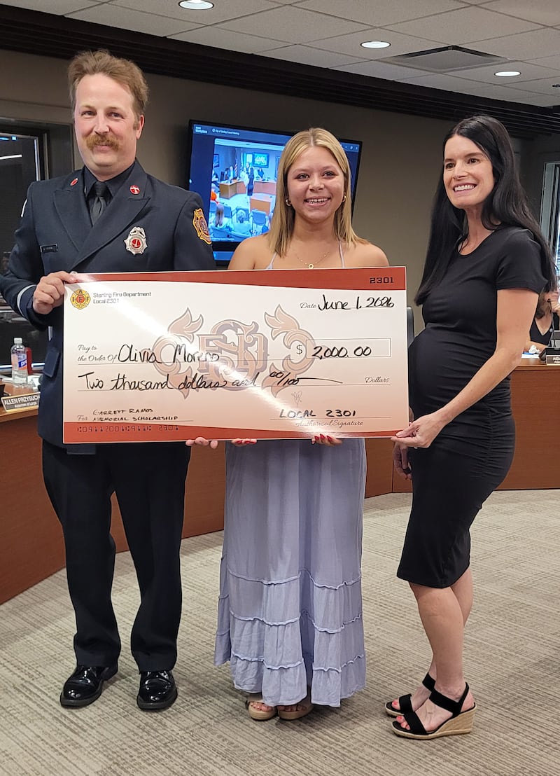 Alivia Moreno, a 2026 Sterling High School graduate, was presented with a $2,000 Garrett Ramos Scholarship at the June 1 Sterling City Council meeting. Presenting the Scholarship are Brittney Ramos, the widow of Garrett Ramos, and Sterling Fire Department Lieut. Vincent Morris.