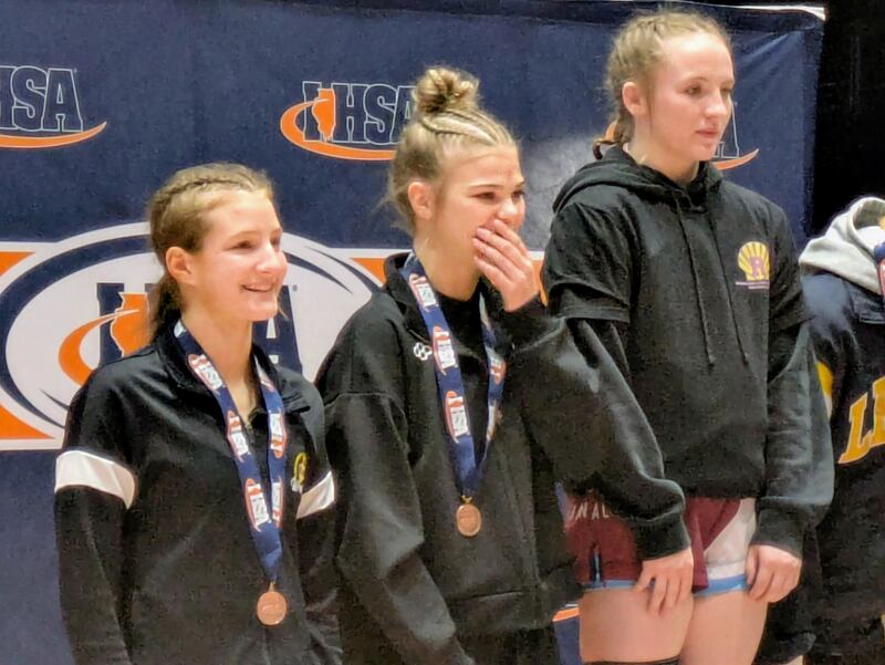 Newman's Blair Grennan reacts after receiving her medal for taking third place at 110 pounds at the IHSA Girls Wrestling State Tournament on Saturday, February 28, 2026 in Bloomington.