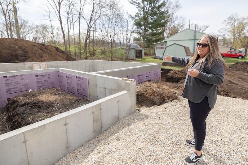 Nichole Richardt gestures towards her developing home Saturday, April 19, 2025, during a groundbreaking ceremony for the 33rd Dixon Habitat for Humanity home build. Ricahardt will share the home with son Isaiah Chattic, 17, and daughter Azareya Chattic, 16.