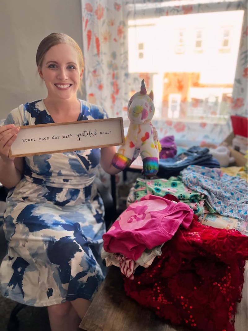 Tiffany Garcea sorts clothing donations for Raising Hope, Erie.