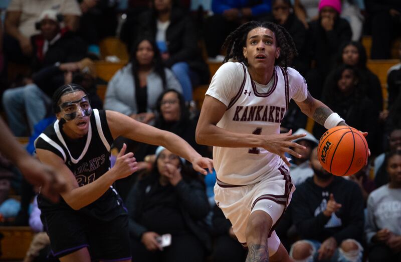 Kankakee's Lincoln Williams makes a drive to the net past Thornton's Manny Padilla, left, in a game on Friday, December 12, 2025.