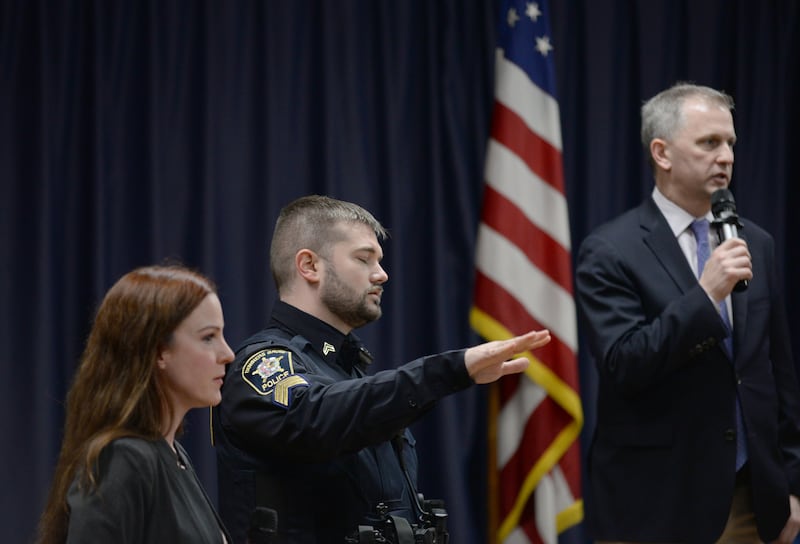 Downers Grove police officers including officer Stults ask people to stay calm and quiet while others were interrupting US Rep Sean Casten during the Downers Grove town hall meeting Wednesday March 19, 2025. The meeting resulted in everyone leaving due to too many people being asked to save the question/answers for a later time while Casten was trying to answer questions and concers regarding the war between Israel and Palestine.