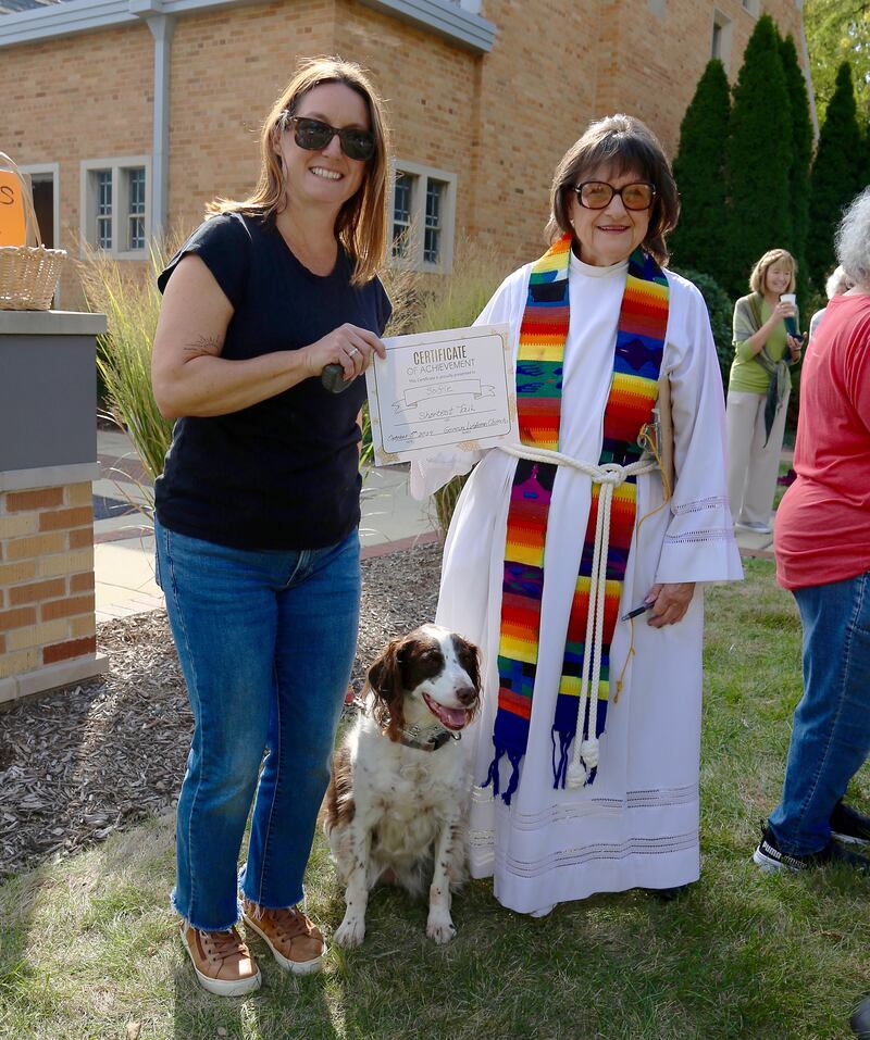 Mandie Meier accepts the prize certificate from Pastor Jane Perkolup that her dog Sofie won after the Blessing of the Animals at Geneva Lutheran Church on Saturday, Oct. 5, 2024.