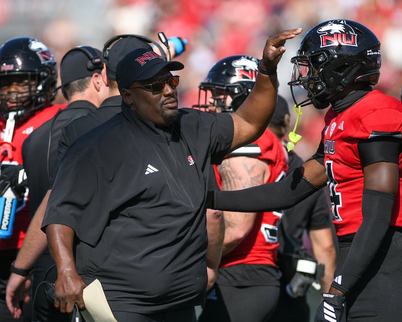 Northern Illinois University's head coach Thomas Hammock talks with Northern Illinois University's safety Muhammed Jammeh (4) during a timeout in the game on Saturday Sept. 27, 2025, while taking on San Diego State held Huskie Stadium in DeKalb.