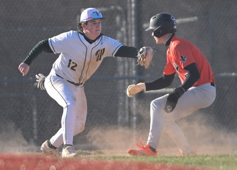 Waubonsie Valley’s Nate Cerilli tags out St. Charles East’s James Feigleson in a baseball game in Aurora on Monday, Mar. 23, 2026.