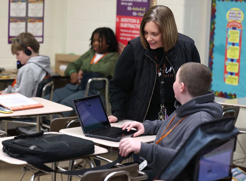 Jenni Smith, an eighth grade math teacher at Huntley Middle School, helps a student Wednesday, March 19, 2025, in her class at the school in DeKalb.