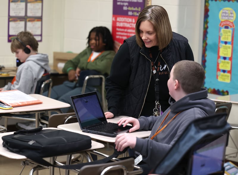 Jenni Smith, an eighth grade math teacher at Huntley Middle School, helps a student Wednesday, March 19, 2025, in her class at the school in DeKalb.