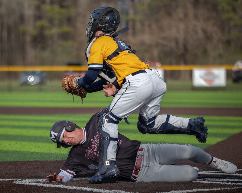 Moline’s Tanner Soucinek is tagged out by Sterling’s Nick Capp Wednesday, April 16, 2025.