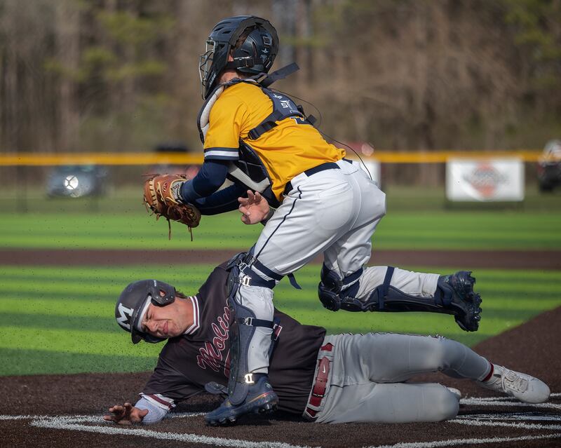 Moline’s Tanner Soucinek is tagged out by Sterling’s Nick Capp Wednesday, April 16, 2025.