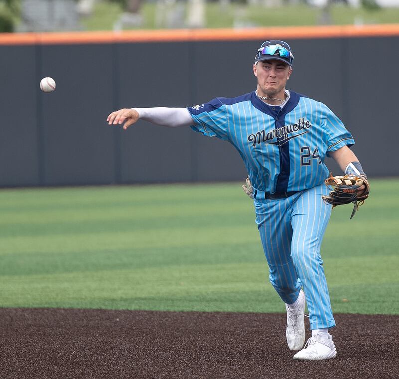 Ottawa Marquette’s Anthony Couch throws to first for an out against Father McGivney Saturday, June 7, 2025, during the Class 1A state baseball final at Illinois Field in Champaign.