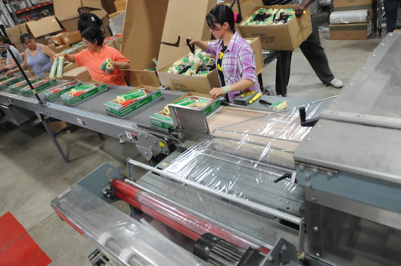 J.R. Edwards Brush & Roller Inc. workers assemble painting kits in the factory warehouse in Kankakee on May 8, 2015.