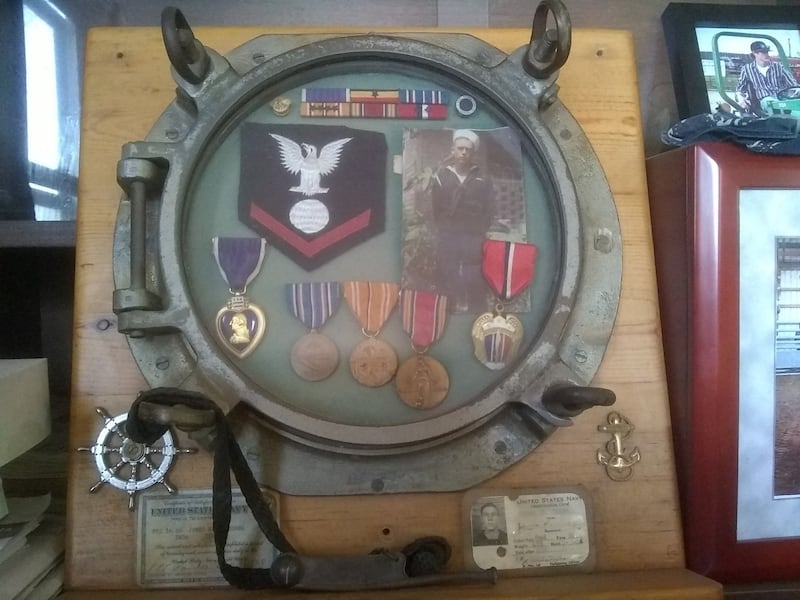 James Combs' Navy porthole is shown along with his medals earned during his service.