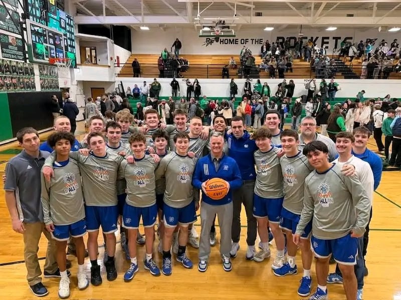 The Newman boys basketball team and coach Ray Sharp, center, are pictured after a 67-41 win at Rock Falls on Tuesday, Jan. 20. It was Sharp's 400th career win.