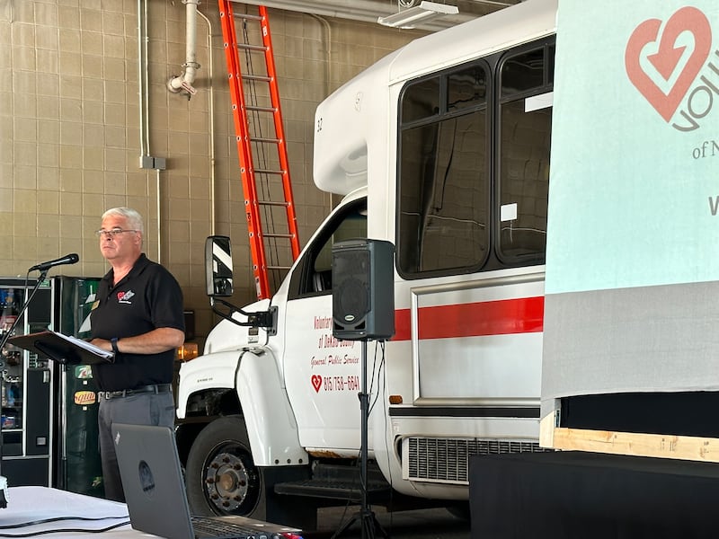 Voluntary Action Center Executive Director Nate Kloster speaks at a Legislative Lunch held at the Voluntary Action Center's garage in Sycamore.