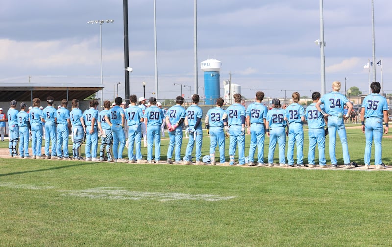 Members of the Marquette baseball team stand for the national anthem during the Class 2A supersectional game on Tuesday, June 9, 2026, at Schweickert Stadium in Peru.