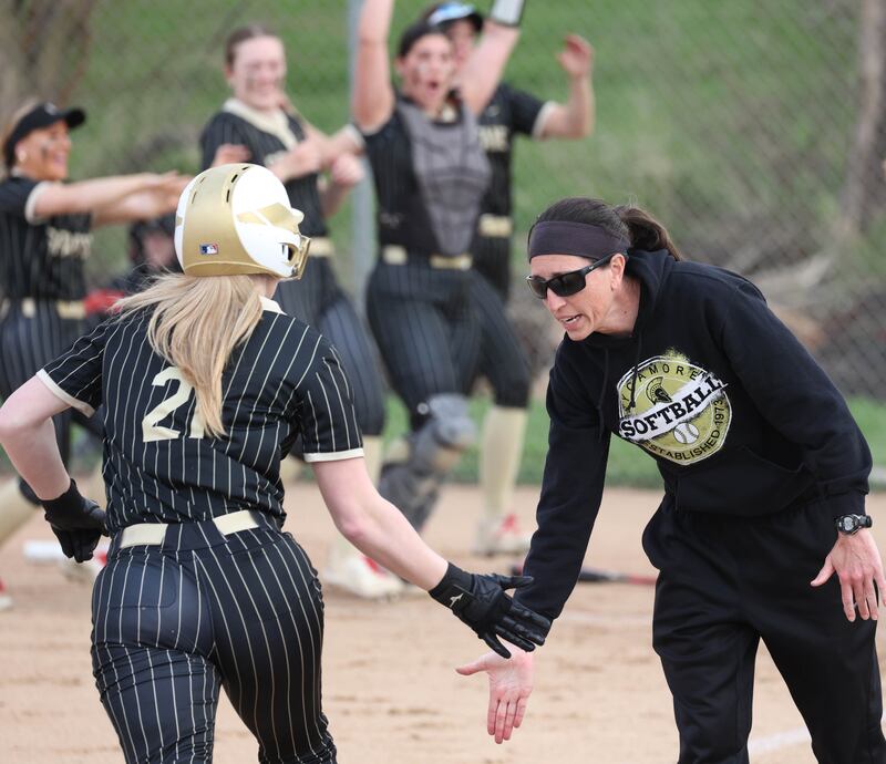 Sycamore head coach Jill Carpenter congratulates Sycamore's Ellison Hallahan as she rounds third after homering Tuesday, April 22, 2025, during their game against Kaneland at Sycamore High School.