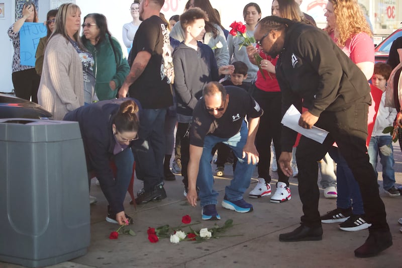 The family of David Malito, 39, and supporters lay down flowers at the spot on Monday, May 5, 2025, where he was on the ground with Joliet police officers who responded to a 911 call from Malito on Dec. 25, 2024 at Shell gas station, 401 S. Larkin Avenue, Joliet.