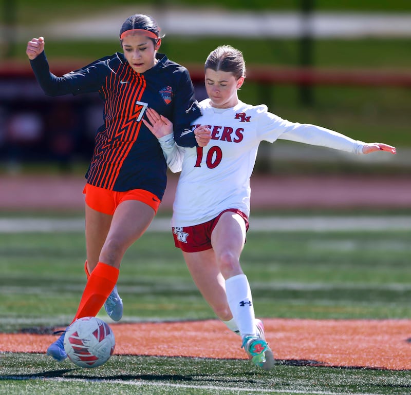 St. Charles East’s Mya Leon, (7) is pressured by Plainfield North’s Molly Nelson, (10) Saturday, March 28, 2026 during the Championship game of the St. Charles East girls soccer invitational.