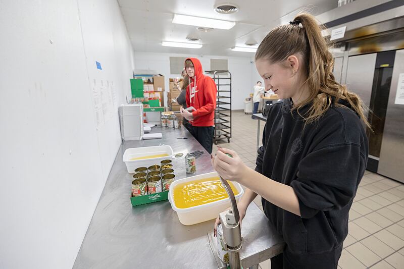Sterling High School student Ruby Dingman opens cans of food Wednesday, Nov. 26, 2025, while volunteering as part of SVCC’s Impact program. A group of students helped prepare meals through the Path to the Future program organized through the Regional Office of Education.