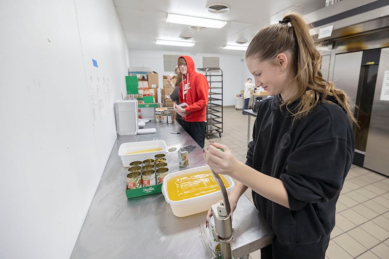 Sterling High School student Ruby Dingman opens cans of food Wednesday, Nov. 26, 2025, while volunteering as part of SVCC’s Impact program. A group of students helped prepare meals through the Path to the Future program organized through the Regional Office of Education.