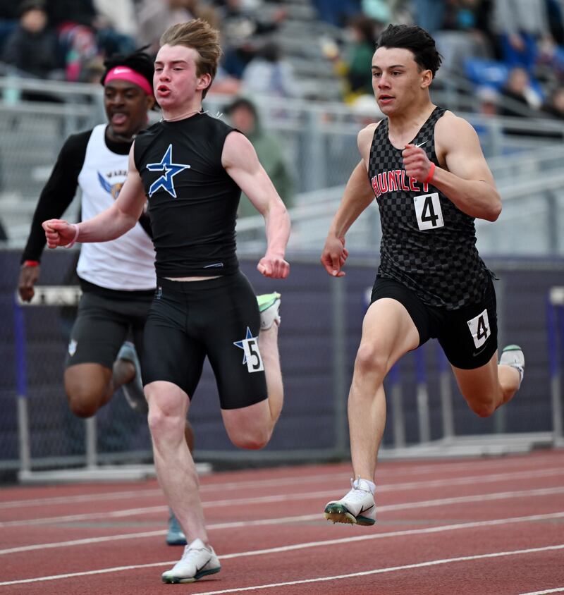 Huntley’s Vinny Costa, right, managed to finish ahead of St. Charles North’s Wylder Smith in the 100-meter dash during the Rolling Meadows boys track meet on Friday, May 2, 2025. Highland Park’s Shamar Wilson finished first with a time of 11.08.