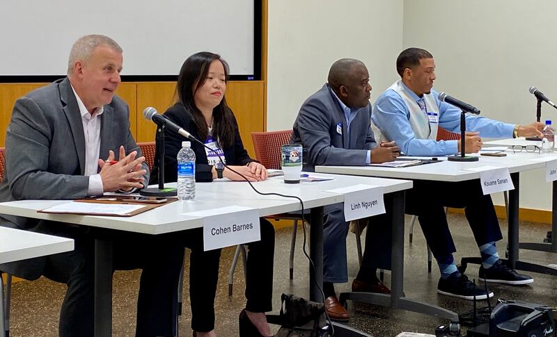 DeKalb incumbent mayor Cohen Barnes (left) seeking a second term, speaks during a question-and-answer period next to opponents (from left) Linh Nguyen, Kouame Sanan and John Walker, at a candidate forum hosted by WNIJ radio and the DeKalb Election Group on Sunday, March 9, 2025, at the DeKalb Public Library, 309 Oak St.