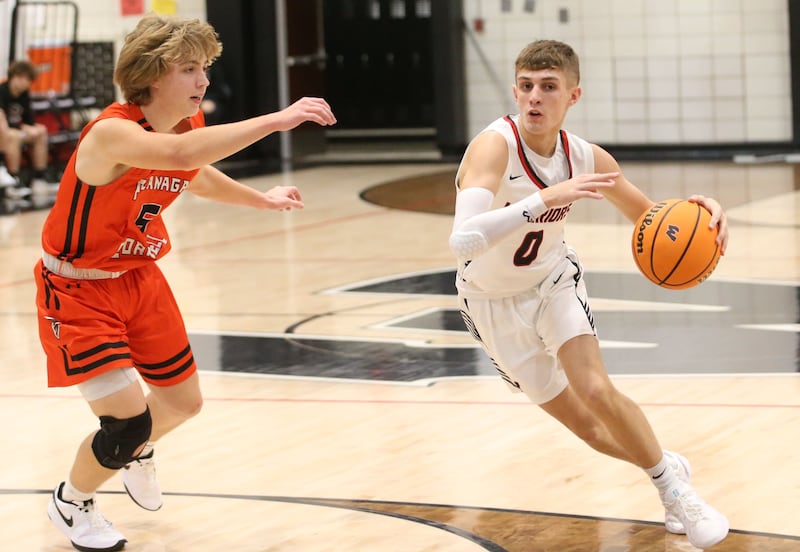 Woodland's Noah Decker looks to pass the ball as Flanagan-Cornell's Mason Rich defends during the Route 17 Classic Tournament on Wednesday, Nov. 27, 2024 at Woodland High School.