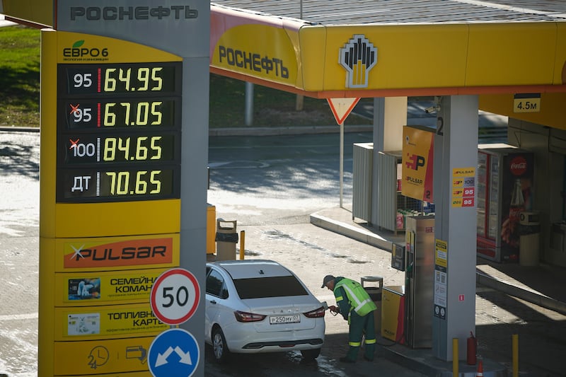 A gas station worker refuels a car in Moscow, Russia, on Aug. 25, 2025. (AP Photo/Pavel Bednyakov)