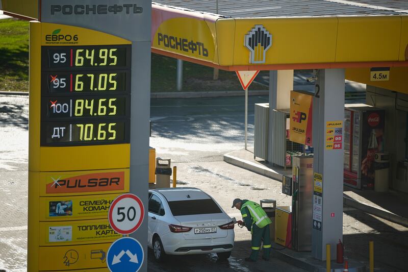 A gas station worker refuels a car in Moscow, Russia, on Aug. 25, 2025. (AP Photo/Pavel Bednyakov)