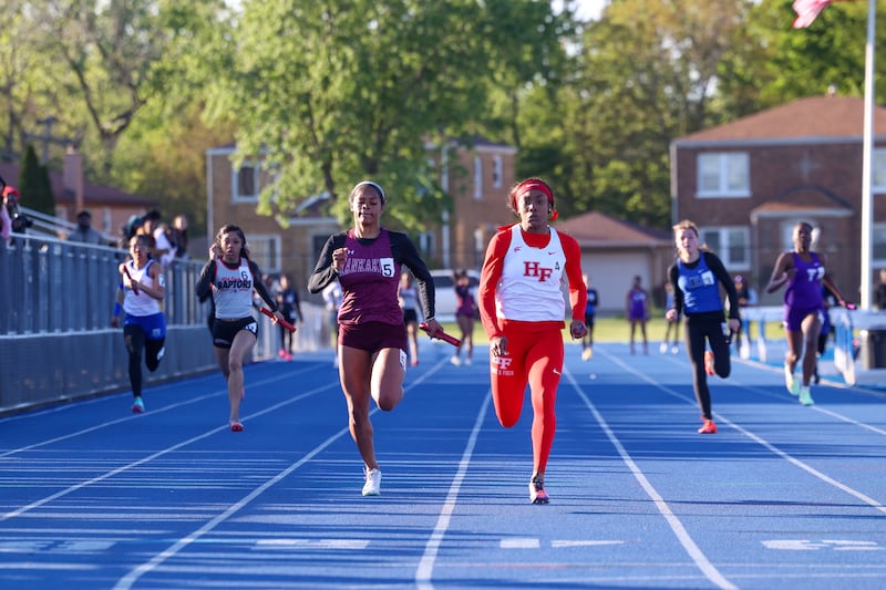 Kankakee's Jasiah Hawkins falls into second behind Homewood-Flossmoor's Aniya Mullins in the 4x100 relay during the IHSA Class 3A Chicago Heights Girls Track and Field Sectional at Bloom High School on Wednesday, May 13, 2026.