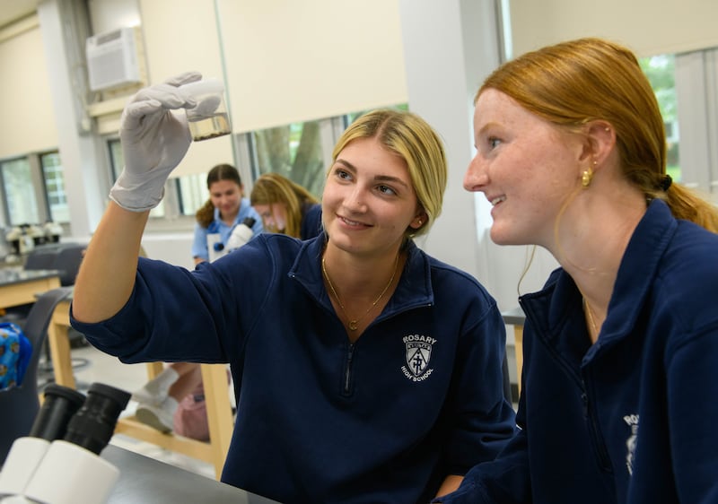 Clare McEniry of North Aurora and Madelyn Stumm of Batavia in their forensic science class at Rosary High School in Aurora. Both are 2025 graduates. The all-girls Catholic school will take on a new name as of July 1, 2025, Rosary College Prep.