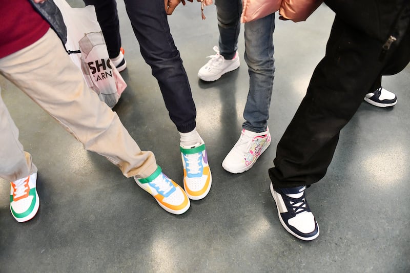 Students show off their new shoes after choosing their favorite pairs at Shoe Carnival as part of the Kankakee Kiwanis Club's annual “All God’s Children Must Have Shoes” event on Feb. 27, 2025.