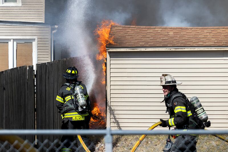 Dixon firefighters hit flames with water Friday, March 14, 2025. Dixon City and Rural responded to a shed fire at 1832 W. First Street.