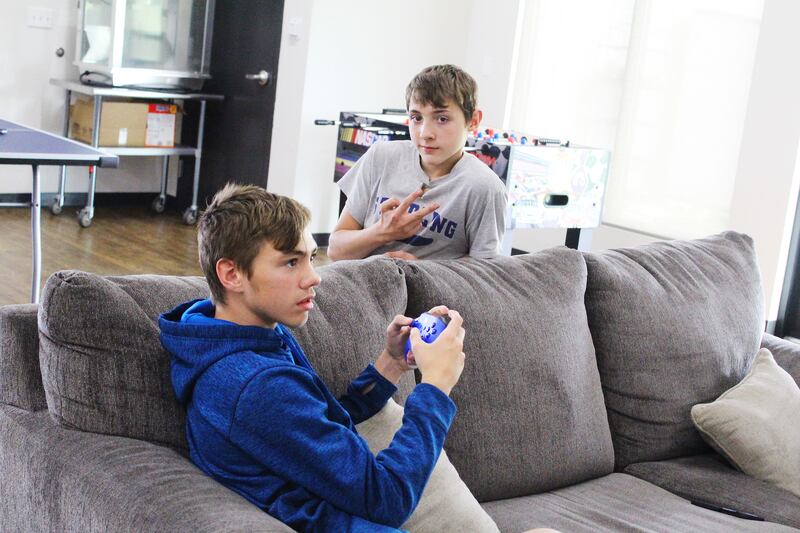 Sterling Township's Elevate Youth Center gives teenagers a place to hang out after school to play, socialize and hone creative interests. Brothers CJ and Jerimiah Bennett enjoy playing a video game on the comfort of one of the center's couches.