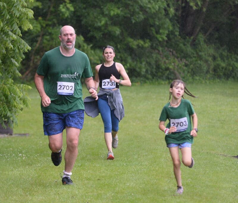 Dane Bell (left), Mara Bell (right) and Mackenzie Turcato (center) run along the lake at the Rochelle Wildlife Conservation Club during the 2024 Infinity Event 5K. This year's event is Saturday, June 14.