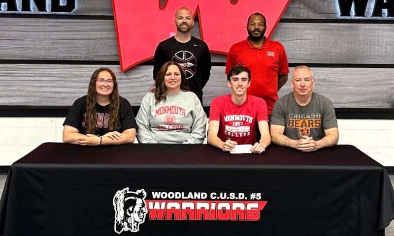 Recent Woodland graduate Nick Plesko – seated third from left at his signing ceremony alongside family members Sydnee, Angie and Jeff Plesko with coaches standing behind – has committed to continue his education at Monmouth College and his basketball career at the NCAA Division III level with the Fighting Scots.