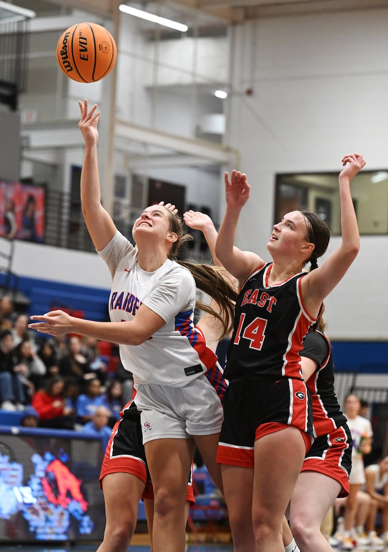 Glenbard South's Callie Hardtke, left, attempts a layup but has her shot blocked by Glenbard East's Teagan Murphy during Friday’s game in Glen Ellyn.