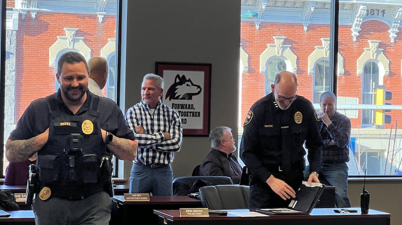 Deputy Sycamore Police Chief Joseph Meeks smiles before a Sycamore City Council meeting on April 6, 2026, while Assistant Public Works Director Jake Keck talks with interim Sycamore Fire Chief Mike Thomas, City Engineer Mark Bushnell talks with 1st Ward Alderman Alan Bauer, and Sycamore Chief of Police Erik Mahan prepares his meeting materials.