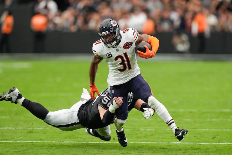 Chicago Bears free safety Kevin Byard (31) is tackled by Las Vegas Raiders center Jackson Powers-Johnson (58) after an interception return during the first half of an NFL game, Sunday, Sept. 28, 2025, in Las Vegas. (AP Photo/John Locher)