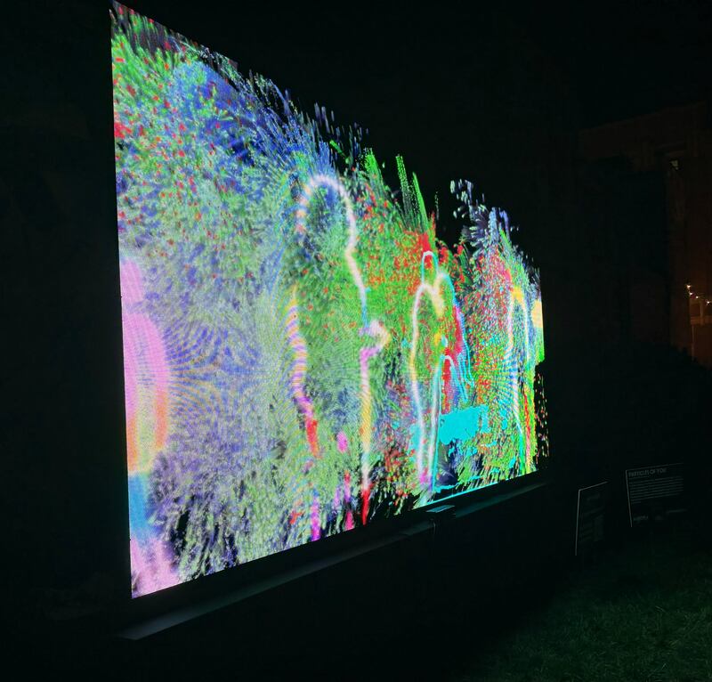 Silhouettes are on display at "Particles of You," one of the installations on display Oct. 10, 2025 as part of Lumenaura in downtown Aurora.